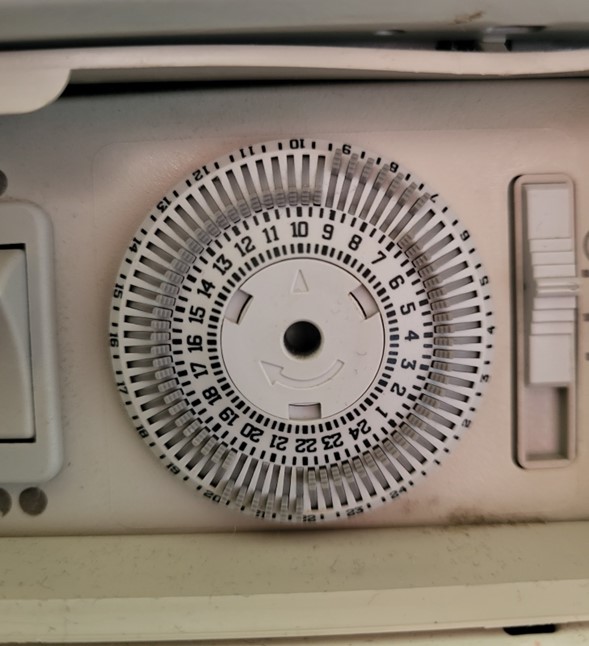 the timer switch of the radiator, with the pins pointing outwards from 7am to 9am and 6pm to 8pm