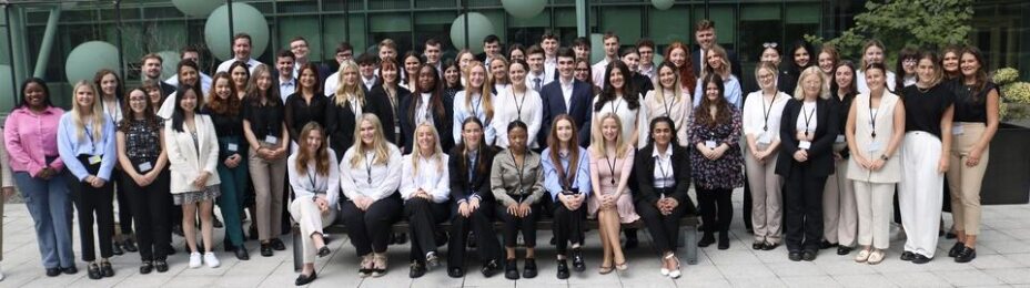 Matheson staff group photo of a diverse group of people outside, in front of a glass building