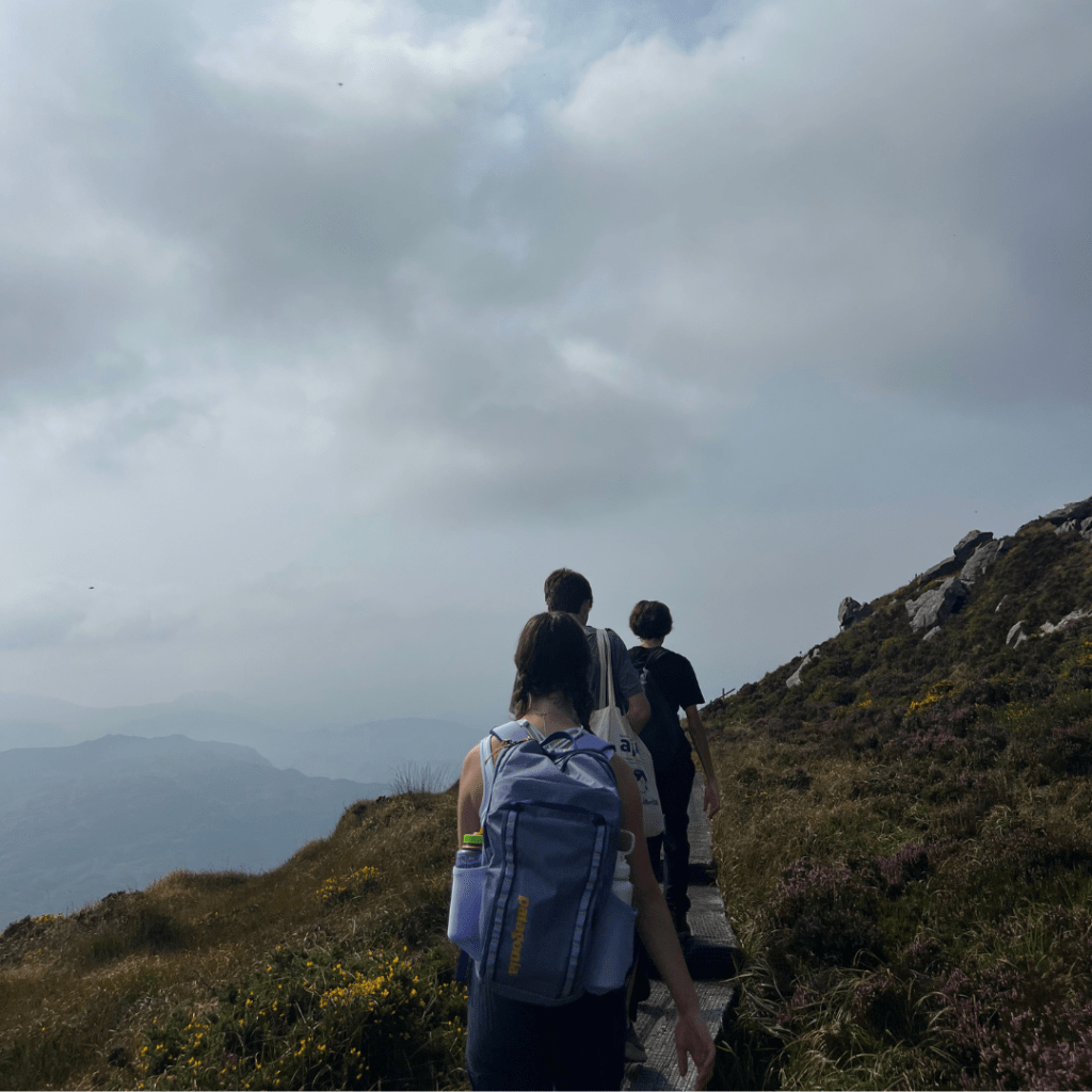 Image of Lauren walking with mountains in the background