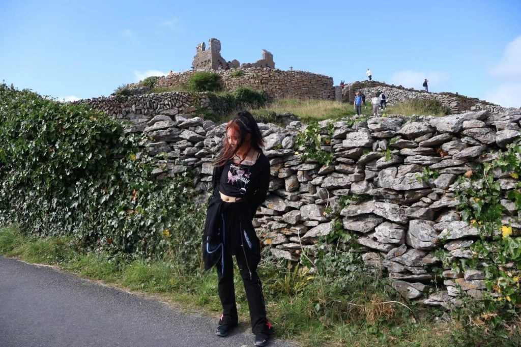 Niri posing in front of a stone wall