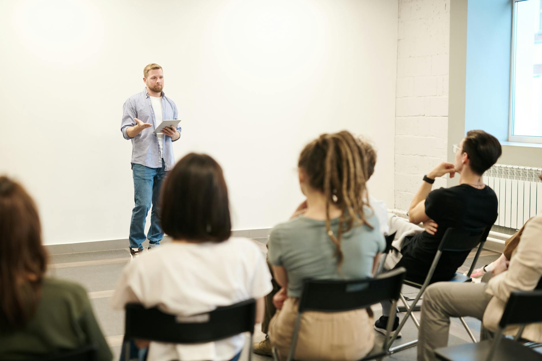 Photo of a blonde man giving a lecture