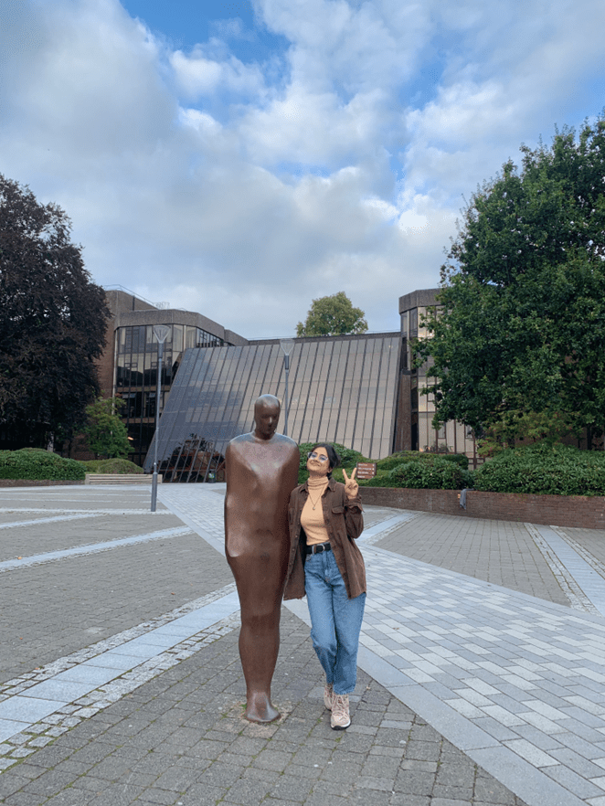 Suchira with Brown Thomas the Together and Alone statue on campus