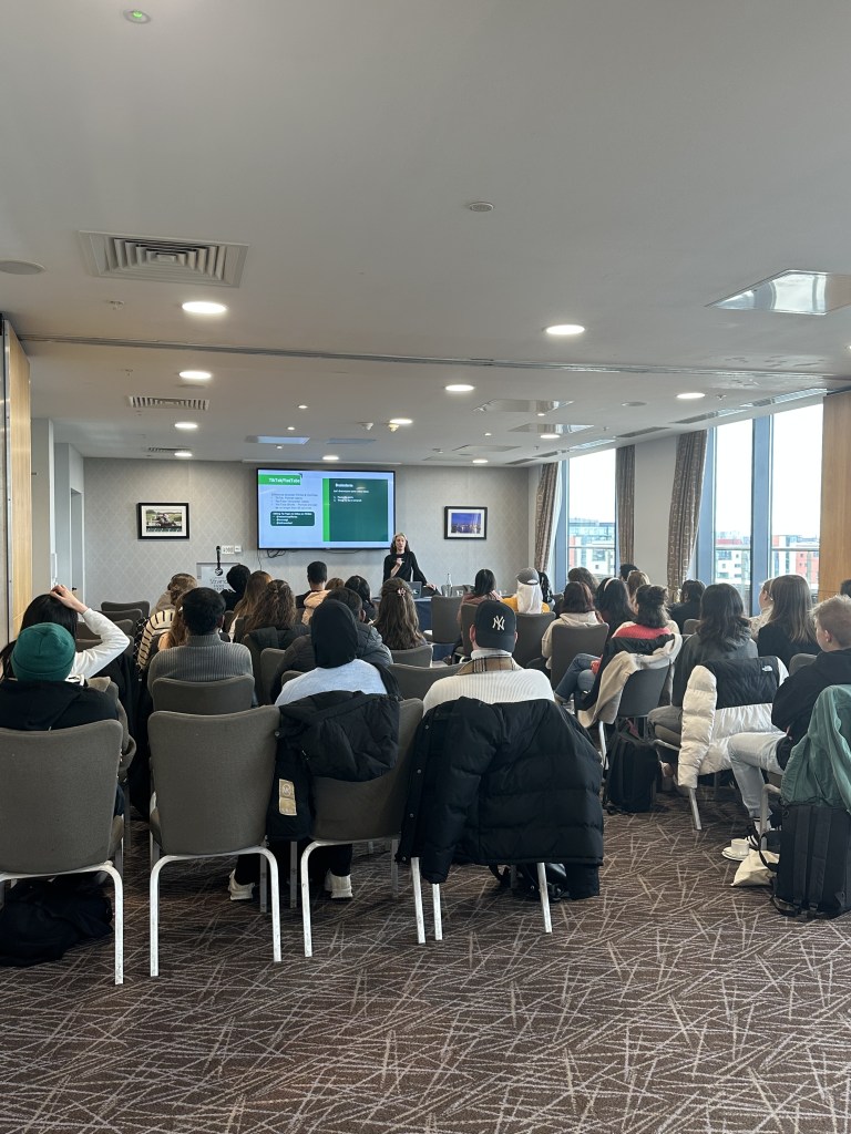 Fiona presents the rules to the Winter '24 Student Ambassadors in the Strand