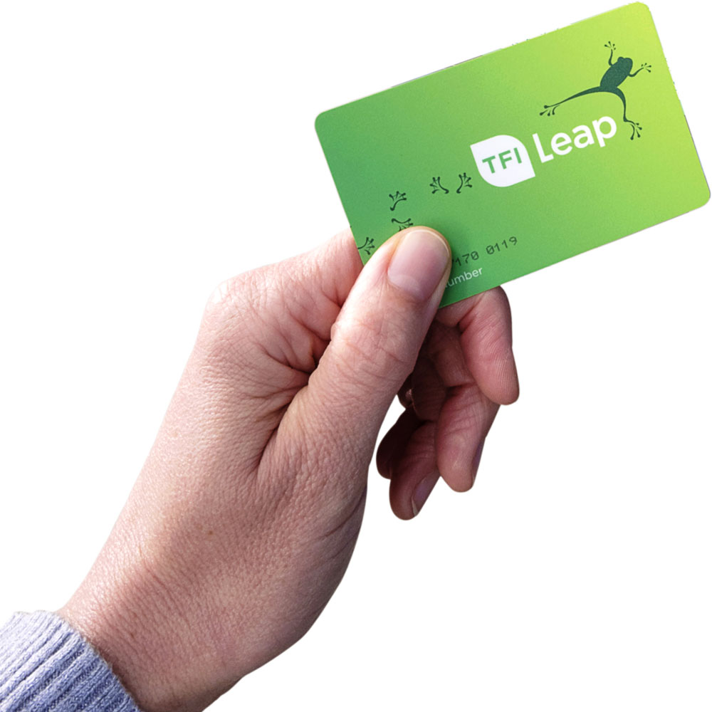 a hand holding a green TFI Leap card