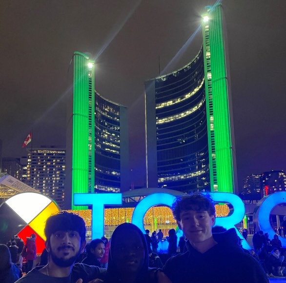 Cian and a friend posing in front of a building.