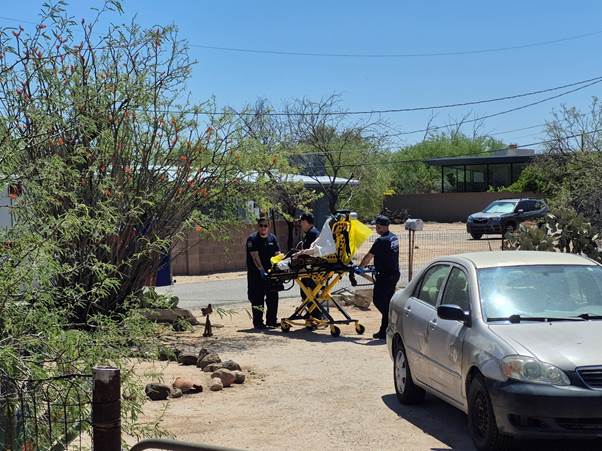 Paramedics escorting a patient on a gurney