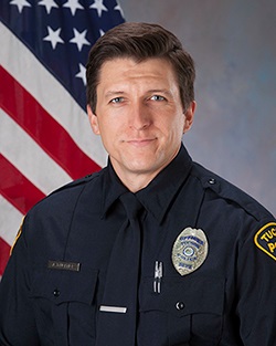 An official photo with the American flag of Adam Buckner