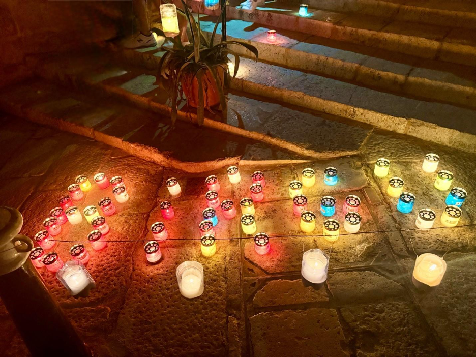 Candles light up to form the word BIRGU