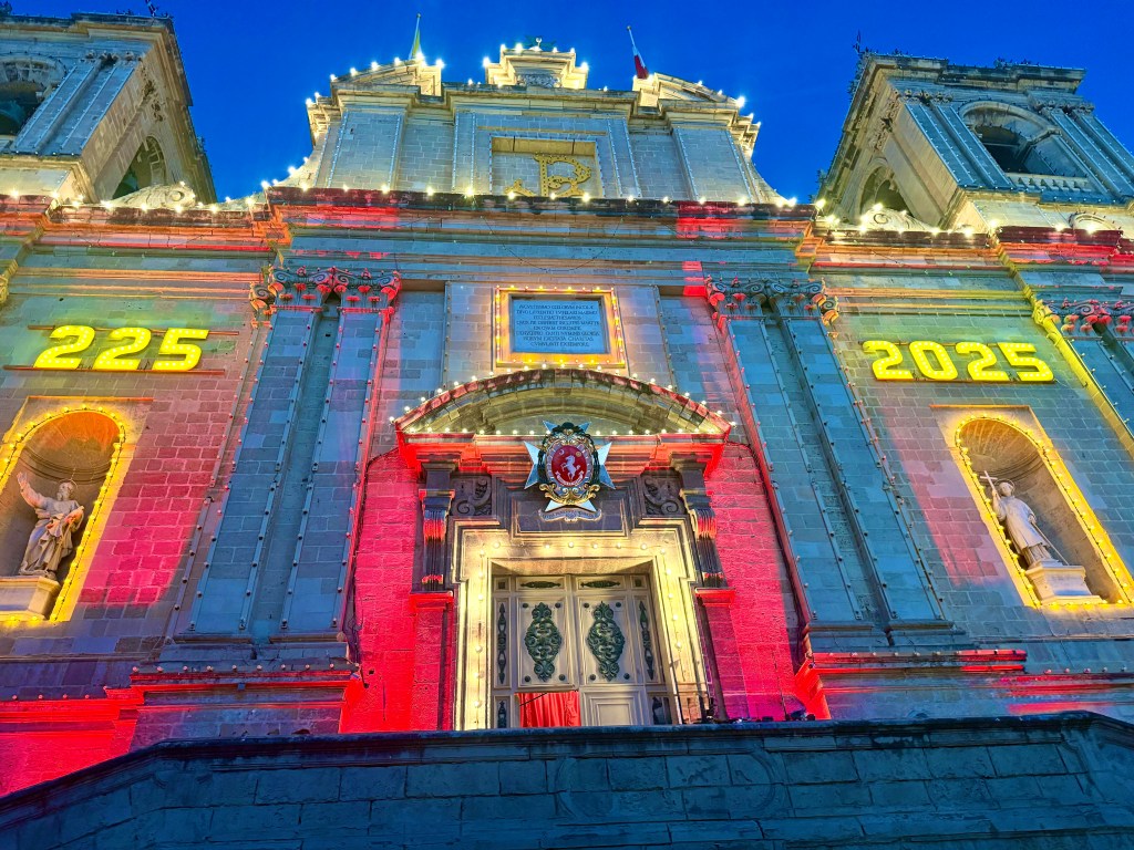 A building light up with neon lights in the evening