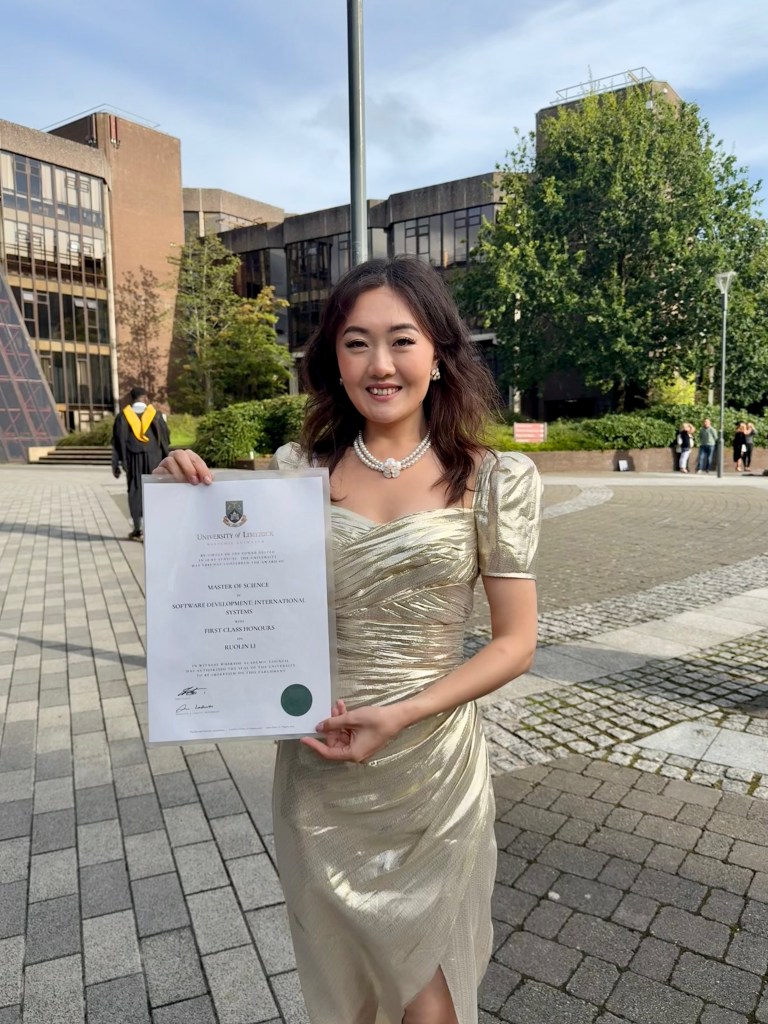 Ruolin holding her graduation's scroll