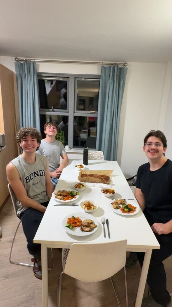 Image of Maddox and friends sitting at the dinner table, having dinner together.