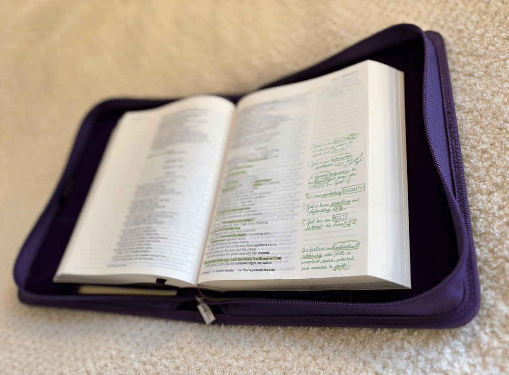 Image of Katies Bible laying in its purple cover case.
