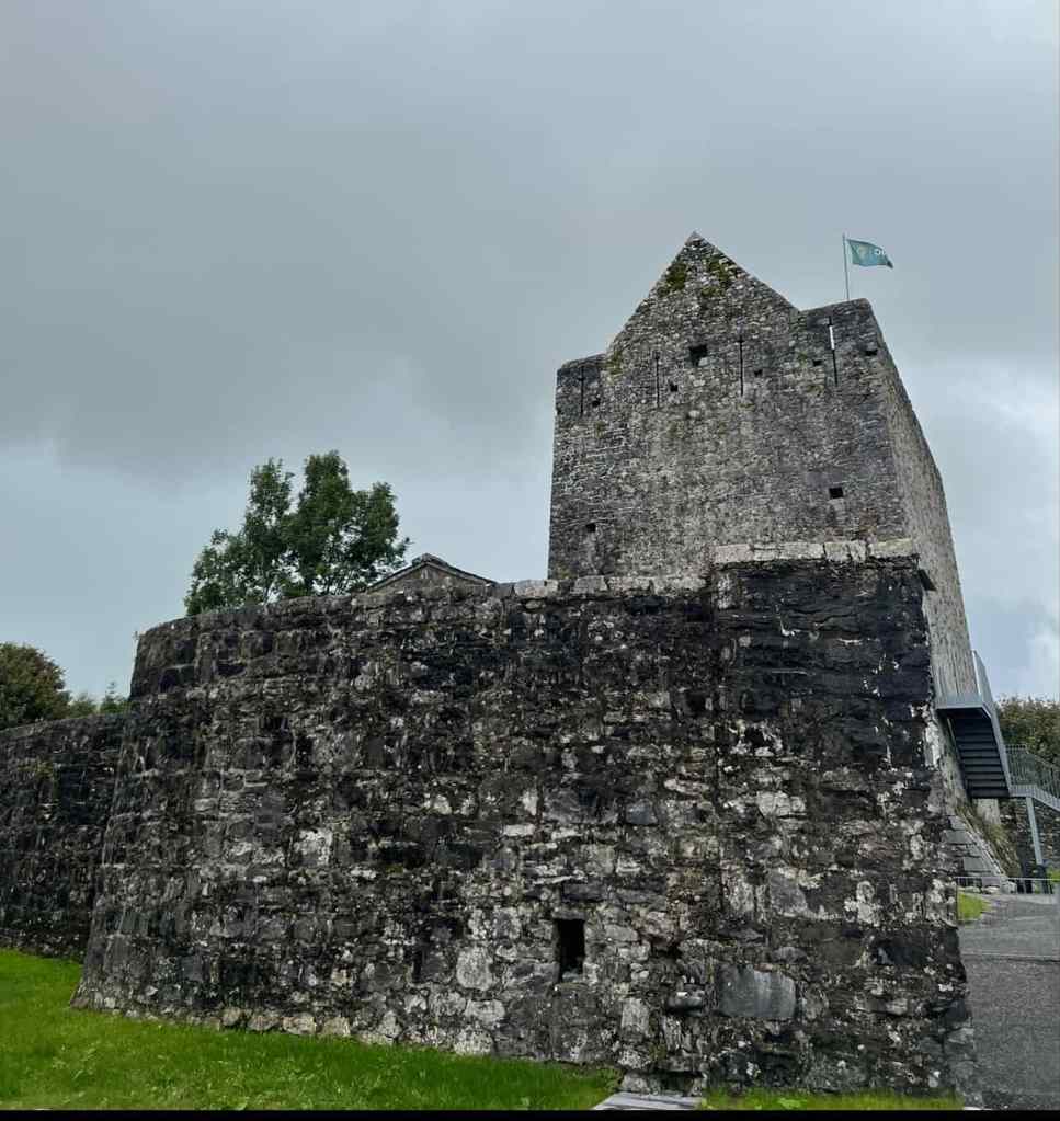 This image shows a view of Athenry Castle, an imposing three-story hall-keep located in County Galway, Ireland. 