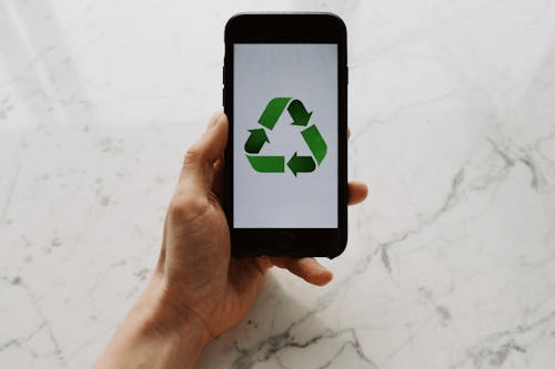 Image of the reduce, reuse, recycle image on a mobile phone.