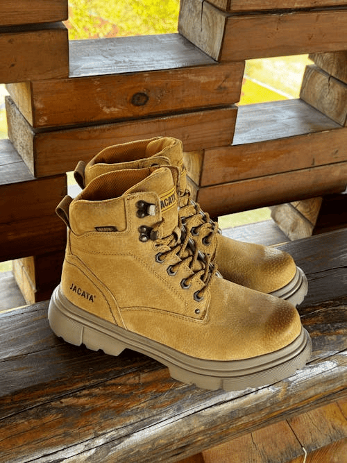 Image of a pair of light brown hiking boots on a wooden seat.
