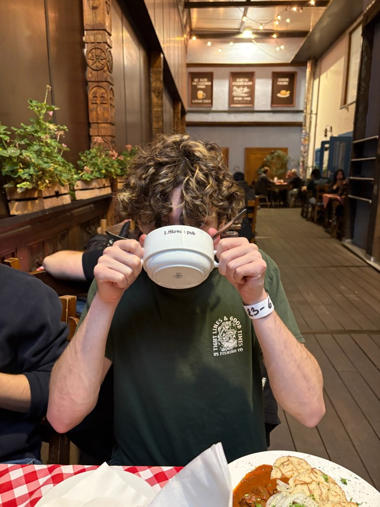 Image of Maddox drinking a beverage whilst out for dinner.