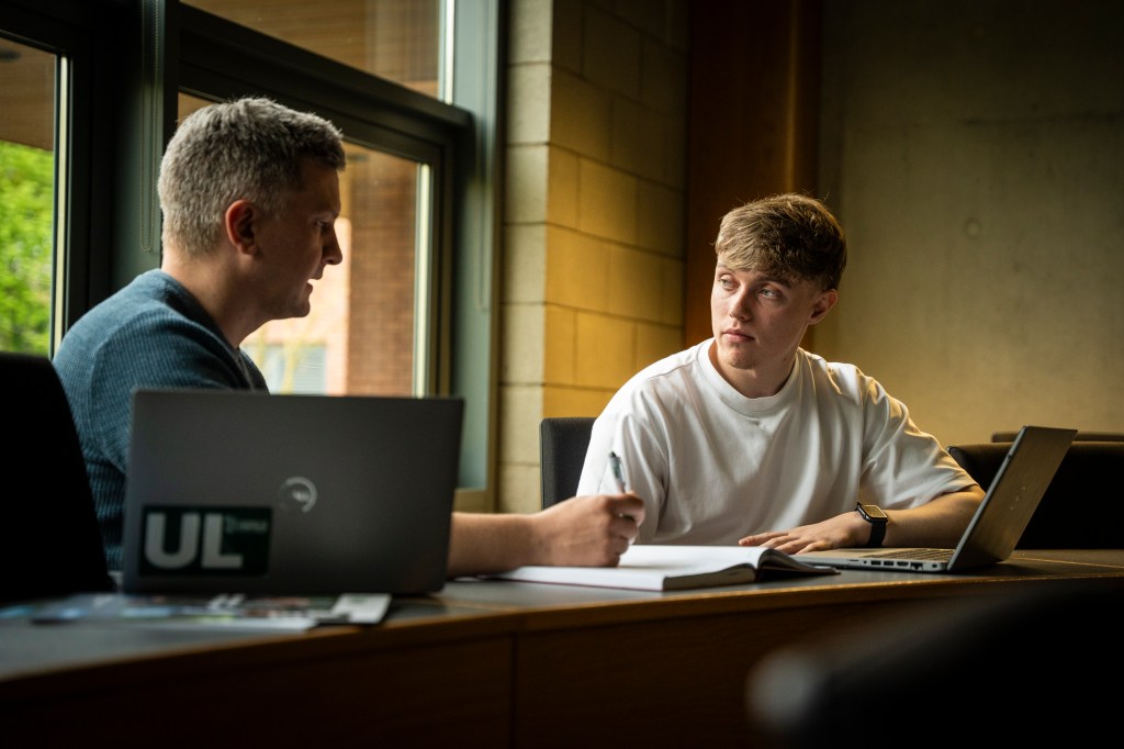 Image of a student having a one to one conversation with a module leader.